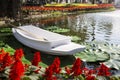 White boat floating on lotus leaf in natural pond with flower garden on backgroun Royalty Free Stock Photo