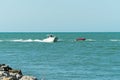 White boat and red car on the ocean water Royalty Free Stock Photo