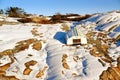 White boat reversed on winter rocky coast