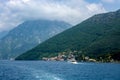 White boat sails along the sea along the mountain coastline Royalty Free Stock Photo