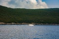 White boat sails along the sea along the mountain coastline Royalty Free Stock Photo