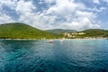 White boat sails along the sea along the mountain coastline Royalty Free Stock Photo