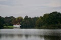 White boathouse on a wooded lake