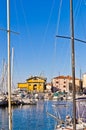 White boats, blue sky and colorful buildings at Piran harbor, Istria