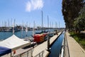 White boats and yachts at the docks in the harbor with deep blue ocean water and blue sky at Burton Chace Park Royalty Free Stock Photo