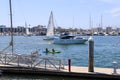 White boats and yachts at the docks in the harbor with deep blue ocean water and blue sky at Burton Chace Park Royalty Free Stock Photo