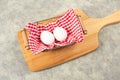 White boiled eggs lying inside a basket on a kitchen towl, breakfast in the morning, cutting board on table Royalty Free Stock Photo