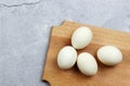 White boiled eggs on a wooden cutting board on a on a light gray background. Royalty Free Stock Photo