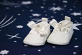 White bootees pair for baby baptism party shower in Romanian tradition celebration Royalty Free Stock Photo