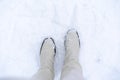 White boots in the snow. Winter walking in snow