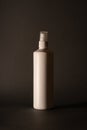 White bottle of cleaning agent on a black background. Vertical frame