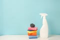 White bottle with cleaning procuct and sponges on blue background with empty space for text Royalty Free Stock Photo