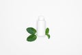 A white bottle with fresh herbs - Mints isolated on white background. For copy space