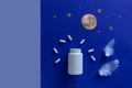 White bottle, pills, moon on blue background. Concept Insomnia, full moon time, sleep problems, soporific. Mockup, Top view,