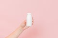 White bottle of probiotic yogurt for digestive system in hand. Dietary supplements for stomach Royalty Free Stock Photo