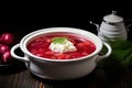 white bowl of borscht contrasted against black tabletop