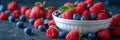 A white bowl contains a mix of raspberries and blueberries Royalty Free Stock Photo