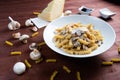 White bowl of cooked Fusilli pasta on the table with cheese, mushrooms and sauces Royalty Free Stock Photo