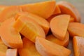 White bowl with cut carrots thick on wooden background Royalty Free Stock Photo