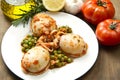 A white bowl with cuttlefish with peas and fresh tomatoes, Royalty Free Stock Photo