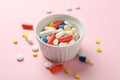 White bowl and different pills on pink background Royalty Free Stock Photo