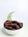 Dates served simply with a crescent moon decor, creating a minimal Muslim holiday background for Ramadan or Eid themes Royalty Free Stock Photo