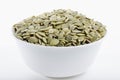 White bowl filled with dried pumpkin seeds