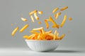 White Bowl Filled With French Fries on Table