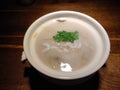 White bowl of fish meat soup on the wooden table Royalty Free Stock Photo