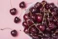 White bowl of fresh red cherries on a pink background. Top view. close-up Royalty Free Stock Photo