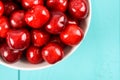 White Bowl Of Fresh Red Cherries On Turquoise Royalty Free Stock Photo