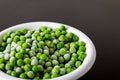 A white bowl with frozen green peas in the kitchen Royalty Free Stock Photo