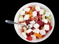 White bowl of greek salad isolated cutout on black bakground. red tomatoes, feta cheese, cucumbers, bulgarian pepper Royalty Free Stock Photo