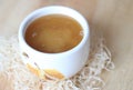 White bowl of honey. Wood table. Rustic style. On a wooden background Royalty Free Stock Photo