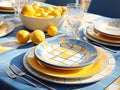 white bowl with lemons and set of ceramic dinner plates in galo-blue tones