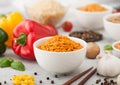 White bowl plates with boiled long grain basmati rice with vegetables and mushrooms on light table background with sticks and