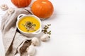 White Bowl of Pumpkin and Mushrooms Soup with Cream and Pumpkin Seeds on Linen Napkin White Wooden Background View From Above Copy Royalty Free Stock Photo