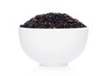 White bowl of raw organic black venus rice on white background. Healthy food Royalty Free Stock Photo