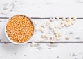 White bowl with raw sweet corn and popcorn on wood Royalty Free Stock Photo