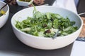 White bowl with salad with arugula