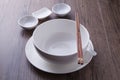 White bowl, spoon, sauce bowl and chopsticks on wood table Royalty Free Stock Photo