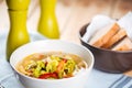 White bowl of vegetable soup, bread, salt and pepper Royalty Free Stock Photo