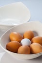 White bowls, easter eggs and golf balls Royalty Free Stock Photo