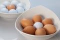 White bowls, easter eggs and golf balls Royalty Free Stock Photo