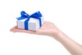 White box with blue ribbon bow gift in hand Royalty Free Stock Photo