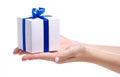 White box with blue ribbon bow gift in hand Royalty Free Stock Photo