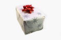 White box, christmas present with stars decorate wrap and red shiny ribbon in white isolated container. Decoration paper for xmas Royalty Free Stock Photo