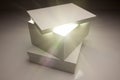 White Box with Lid Revealing Something Very Bright Royalty Free Stock Photo