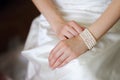 White bracelet on a hand of the bride