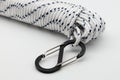 White braided polypropylene rope with black carabiner isolated on white background